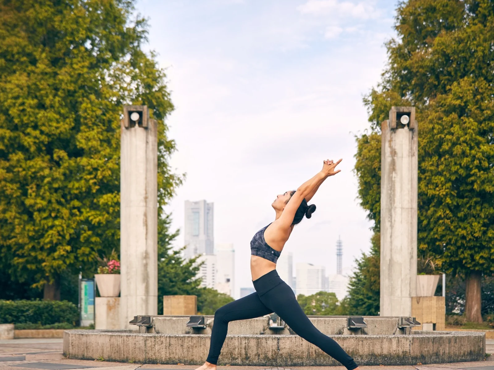 Miné practicing yoga outdoors in Tokyo